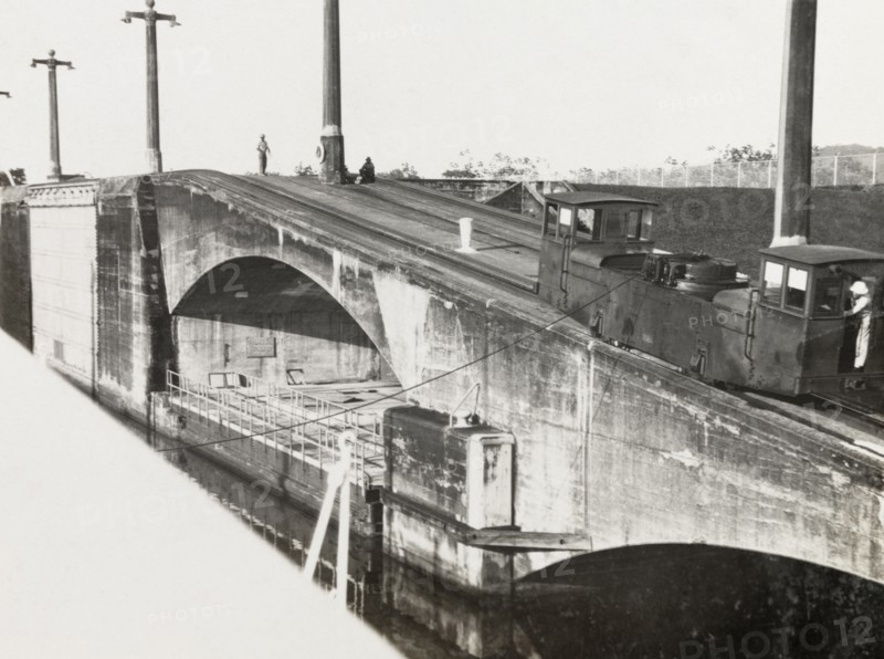 Mole on Panama Canal. A railcar runs along the top of a stone mole by the Panama Canal. Panama, circa 1931. Panama, Central America, North America .