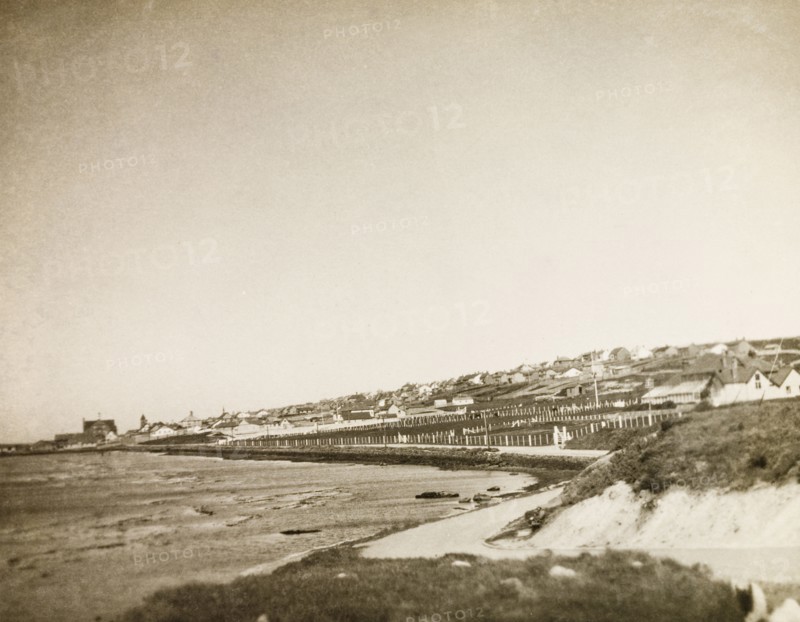 Port Stanley, East Falkland. View along the coastline of the the isle of East Falkland to the town of Stanley. Stanley, Falkland Islands, circa 1931. Stanley, East Falkland, Falkland Islands, South Atlantic Ocean, South America .