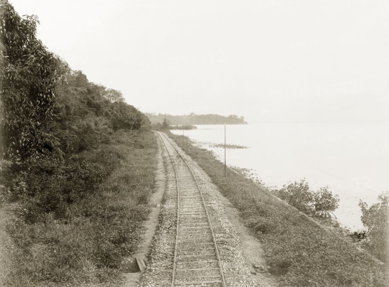 Trinidad Government Railway line. View of a section of railway track built by Trinidad Government Railways bordering the coastline as it travels enroute to Port of Spain. Trinidad, circa 1912., Trinidad and Tobago, Trinidad and Tobago, Caribbean, North America .