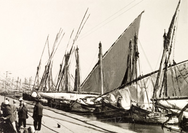 Docks on Suez Canal. Rows of sail boats are moored at docks on the Suez Canal. Suez, Egypt, 1930. Suez, Suez, Egypt, Northern Africa, Africa.