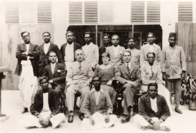Office staff of 'James Murray and Company'. The office staff of 'James Murray and Company' pose for a group portrait. The owner, James Murray, sits in the middle row (second to right) next to the store manager and his wife. Calcutta (Kolkata), India, 1932. Kolkata, West Bengal, India, Southern Asia, Asia.