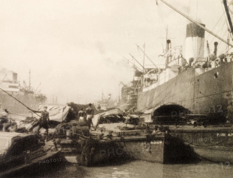 Vessels at Calcutta docks. River barges butt up against huge steamships at Calcutta docks on the Hooghly River. Calcutta (Kolkata), India, circa 1930. Kolkata, West Bengal, India, Southern Asia, Asia.