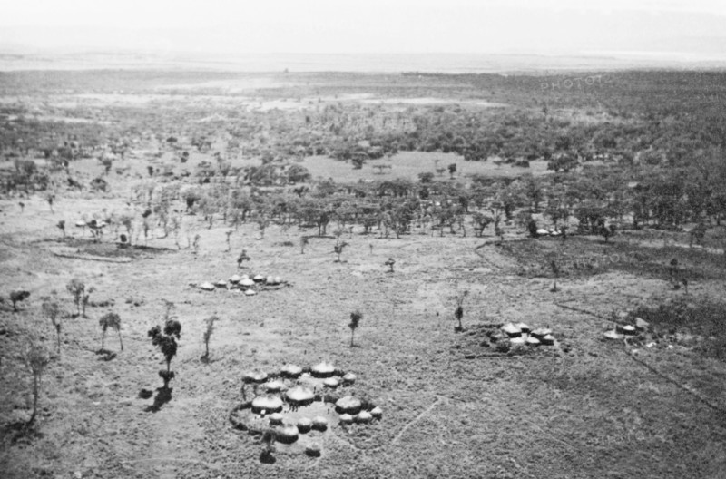 A Luo settlement on the Kano plains. Clusters of huts comprise a Luo settlement on the Kano plains, close to Lake Victoria. Nyanza, Kenya, circa 1935., Nyanza, Kenya, Eastern Africa, Africa.
