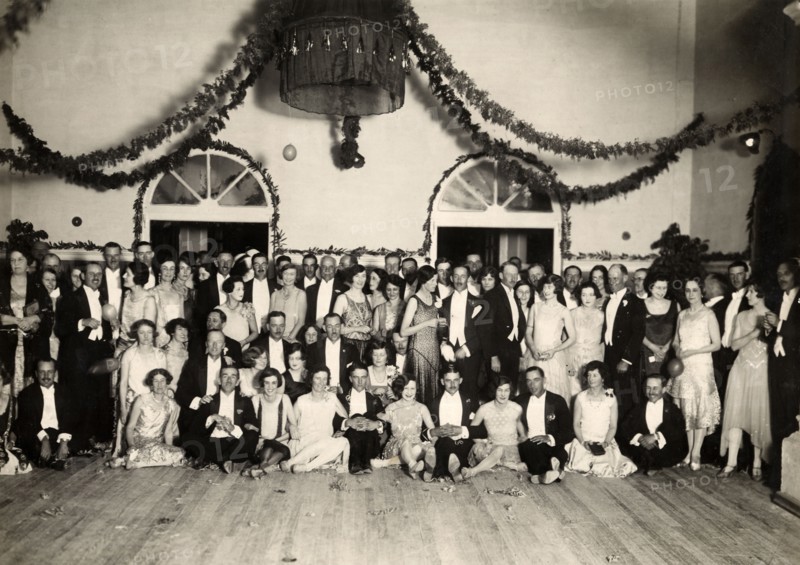 Aftershow party at Orpheus Theatre. Group portrait of officers of the West Yorkshire Regiment (The Prince of Wales's Own) with their wives and cabaret performers at a concert hall, following a performance at the Orpheus Theatre. Mhow, Indore State (Madhya Pradesh), India, March 1929. Indore, Madhya Pradesh, India, Southern Asia, Asia.