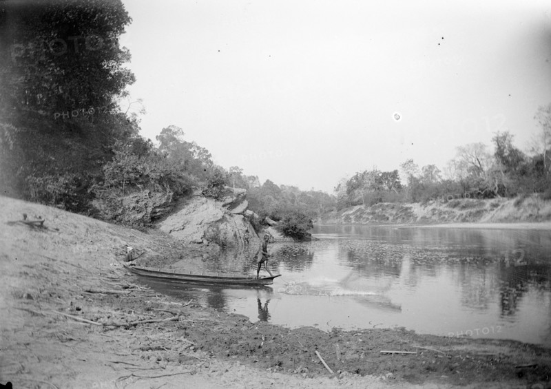 Burmese fisherman. A fisherman casts his net into the shallows of a river from the bow of his canoe. Burma (Myanmar), circa 1890. Burma (Myanmar), South East Asia, Asia.
