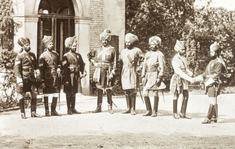 Sikh officers loyal to the British Army. Eight Sikh officers stand in the driveway of a colonial building at around the time of the Indian Mutiny and Rebellion (1857-58). Sikh soldiers enlisted with the British Army at the end of the Second Anglo-Sikh War (1848-49) and remained loyal to the British throughout the rebellion. India, circa 1860. India, Southern Asia, Asia.