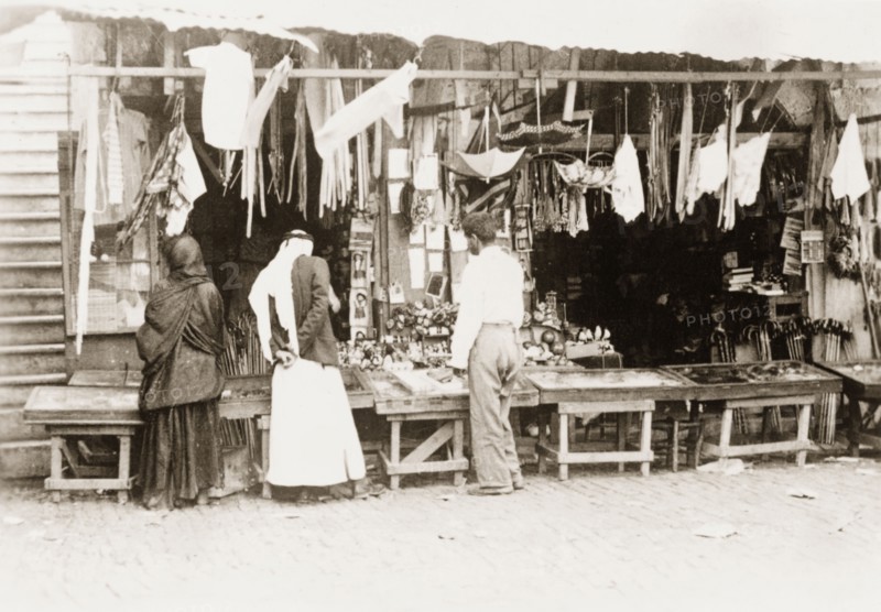 Stall at a 'shuk', Palestine. Shoppers browse a variety of items for sale on a stall at a 'shuk' (open air market). British Mandate of Palestine (Middle East), circa 1938., Middle East, Asia.