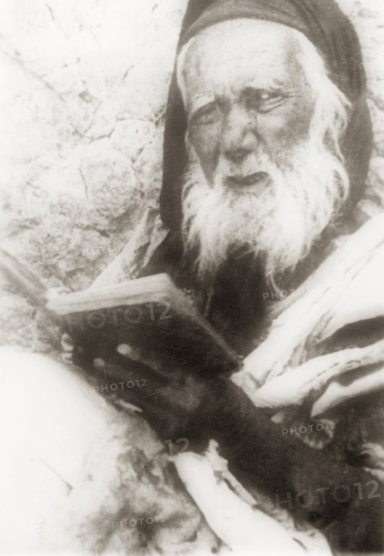 Portrait of an elderly Arab man. Portrait of an elderly Arab man reading from a book. British Mandate of Palestine (Middle East), circa 1938., Middle East, Asia.