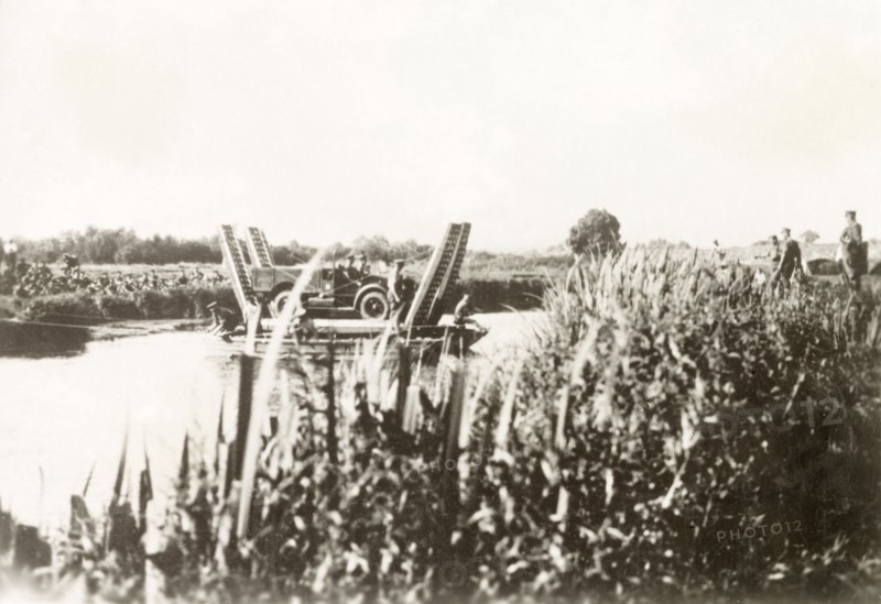Cable ferry in Palestine. A British military vehicle is transported across a river on a cable ferry. During the period of the Great Uprising (1936-39), an additional 20,000 British troops were deployed to Palestine in an attempt to clamp down on Arab dissidence. British Mandate of Palestine (Middle East), circa 1938., Middle East, Asia.