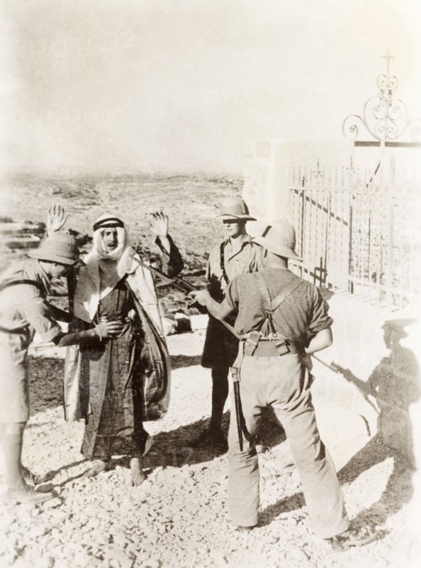 British soldiers searching a Palestinian Arab. Two British soldiers perform a body search on a Palestinian Arab suspect, while a third points a bayonetted rifle at his head. During the period of the Great Uprising (1936-39), an additional 20,000 British troops were deployed to Palestine in an attempt to clamp down on Arab dissidence. British Mandate of Palestine (Middle East), circa 1938., Middle East, Asia.