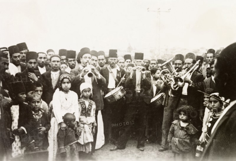 A traditional Arab wedding. Group portrait of male guests, children and musicians at a traditional Arab wedding. British Mandate of Palestine (Middle East), circa 1938., Middle East, Asia.