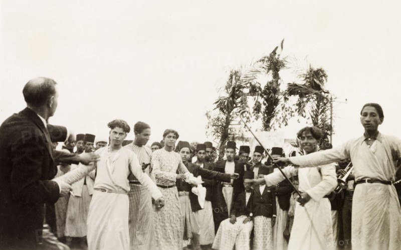 Dancing at an Arab wedding, Palestine. Several men perform a traditional dance at an Arab wedding. British Mandate of Palestine (Middle East), circa 1938., Middle East, Asia.