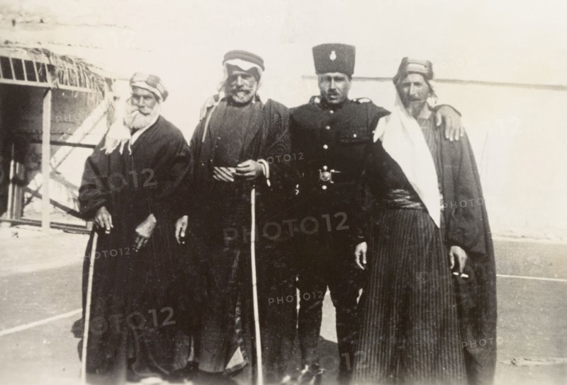 Palestinian police officer with 'mukhtars'. An officer of the Palestine Police Force poses for a group portrait with three Arab 'mukhtars' (village leaders). British Mandate of Palestine (Middle East), circa 1938., Middle East, Asia.