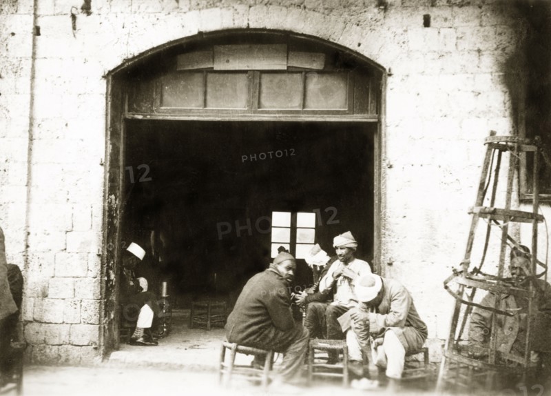 A Palestinian cafe. A group of Arab men socialise in the doorway of a cafe. British Mandate of Palestine (Middle East), circa 1938., Middle East, Asia.