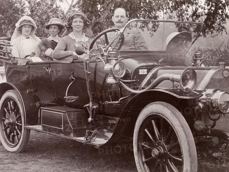 Driving an Itala car, India. Three European women and their male companion take a spin in a convertible Itala car. An original caption identifies the man as 'Pining Peliti, famous for his restaurants in Calcutta and Simla', and suggests this may be Italian restaurateur, Federico Peliti. Probably Calcutta (Kolkata), India, circa 1916. Kolkata, West Bengal, India, Southern Asia, Asia.