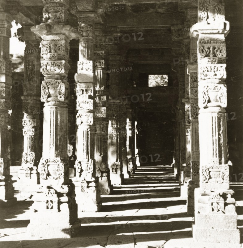 Carved pillars at the Quwwat-ul-Islam Mosque. Intricately carved stone pillars line a passageway at the Quwwat-ul-Islam Mosque. Delhi, India, 1941. Delhi, Delhi, India, Southern Asia, Asia.