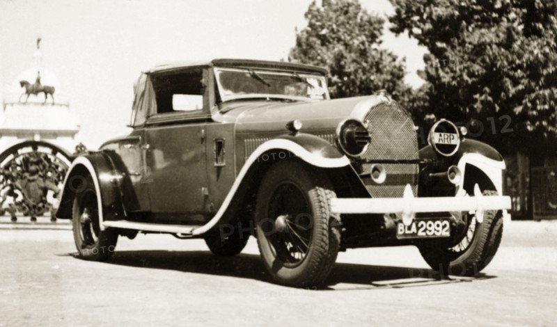 A Hotchkiss 1928, in a rich red'. A 1928 Hotchkiss car, parked outside the gates of the Victoria Memorial. The vehicle belonged to British businessman James Murray who comments in an original caption: "A real gem and one of my favourite cars". Calcutta (Kolkata), India, 1943. Kolkata, West Bengal, India, Southern Asia, Asia.