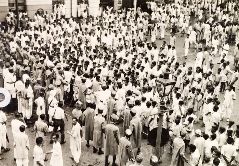 Policing the riots in Calcutta, 1946. Indian police form a barricade with lathis (bamboo sticks) to control crowds of Indian protesters on Old Court House Street. The photographer refers to the event as a "Communist demo", but it could be any one of a number of uprisings that plagued Calcutta in 1946. Two occasions that seem to fit are an attempt by student demonstrators to enter Dalhousie Square on 11 February, or the August riots relating to Direct Action Day. Calcutta (Kolkata), India, 1946. Kolkata, West Bengal, India, Southern Asia, Asia.