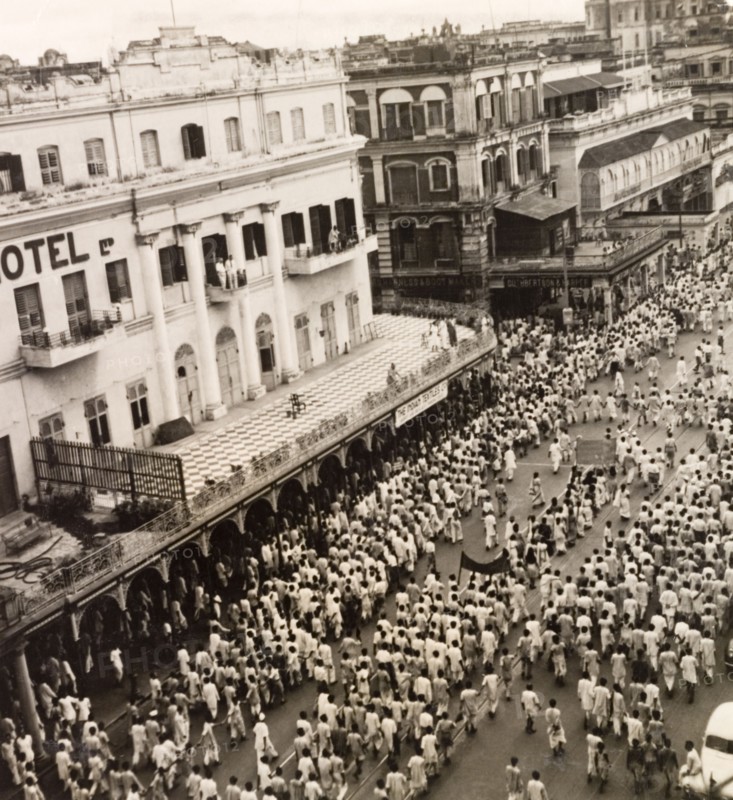Protest on Old Court House Street, Calcutta, 1946. A crowd of Indian protesters brandish banners as they march along Old Court House Street. The photographer refers to the event as a "Communist demo", but it could be any one of a number of uprisings that plagued Calcutta in 1946. Two occasions that seem to fit are an attempt by student demonstrators to enter Dalhousie Square on 11 February, or the August riots relating to Direct Action Day. Calcutta (Kolkata), India, 1946. Kolkata, West Bengal, India, Southern Asia, Asia.