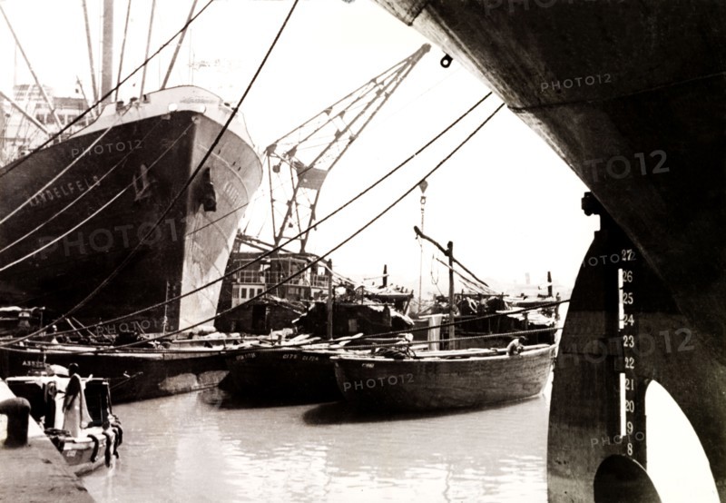 Calcutta docks, 1930. Steamships and barges are moored at Calcutta docks. Calcutta (Kolkata), India, circa 1930. Kolkata, West Bengal, India, Southern Asia, Asia.