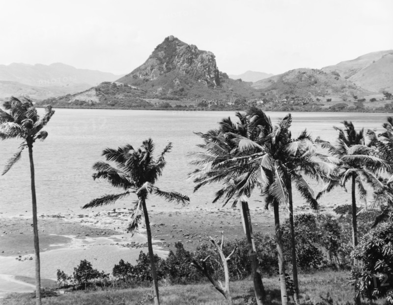 Rocky outcrop on Viti Levu. A distinctive rocky outcrop is seen across a bay on the eastern side of Viti Levu. Viti Levu, Fiji, 1965., Viti Levu, Fiji, Pacific Ocean, Oceania.