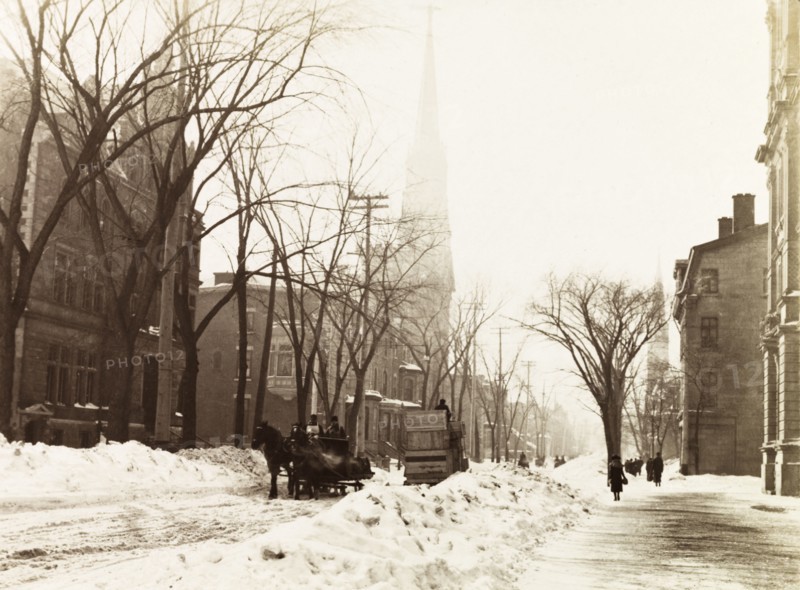 Snow covered Dominion Square, Montreal. View of the western side of Dominion Square (Dorchester Square) outside the Windsor Hotel, where two horses pull a sledge along the snow covered ground. Montreal, Canada, February 1902. Montreal, Quebec, Canada, North America, North America .