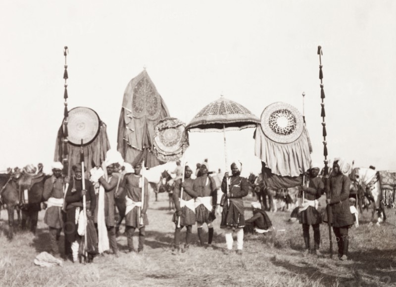 Standard-bearers of Rewah State, 1903. The standard-bearers of Rewah State display a selection of ceremonial umbrellas, banners and staffs at the Coronation Durbar. Delhi, India, circa 1 January 1903. Delhi, Delhi, India, Southern Asia, Asia.