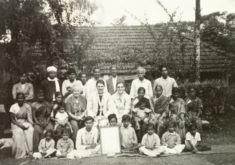 Reverend and congregation at Indian plantation. British missionary Reverend Norman Sargant (centre) poses for a group portrait with his Methodist congregation outside a colonial bungalow at a tea or coffee estate. Mysore State (Karnataka), India, 1938., Karnataka, India, Southern Asia, Asia.