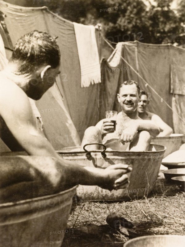 A cold tub for the Calcutta Scottish. Officers of the Calcutta Scottish, an infantry regiment of the British Indian Army, take a cold bath at their outdoor camp after a day on manoeuvres. Midnapore, Bengal (West Bengal), India, 1932. Midnapore, West Bengal, India, Southern Asia, Asia.