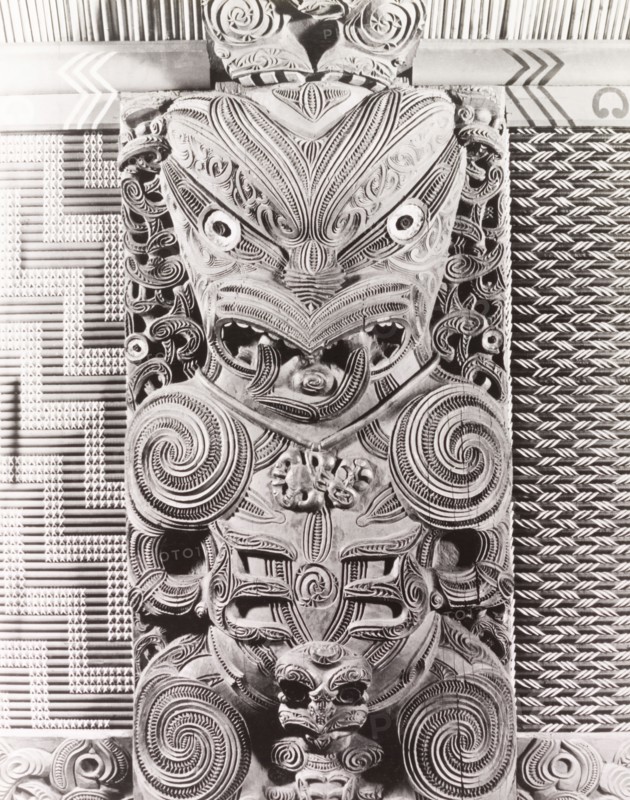 Maori 'tekoteko' panel. Close-up shot of a Maori 'tekoteko' panel, a human-like figure carved from wood and elaborately decorated with swirling patterns. An original caption comments: "(This) panel is in the interior of the Tamtekapu meeting house in Rotorua". Rotorua, New Zealand, 1966. Rotorua, Bay of Plenty, New Zealand, New Zealand, Oceania.