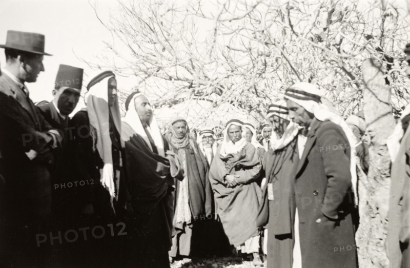 William Ryder McGeagh talks to Arab villagers. William Ryder McGeagh (left), District Commissioner in Jerusalem, talks to a group of Arab men whilst visiting a rural Arab village. British Mandate of Palestine (Israel), circa 1940. Israel, Middle East, Asia.
