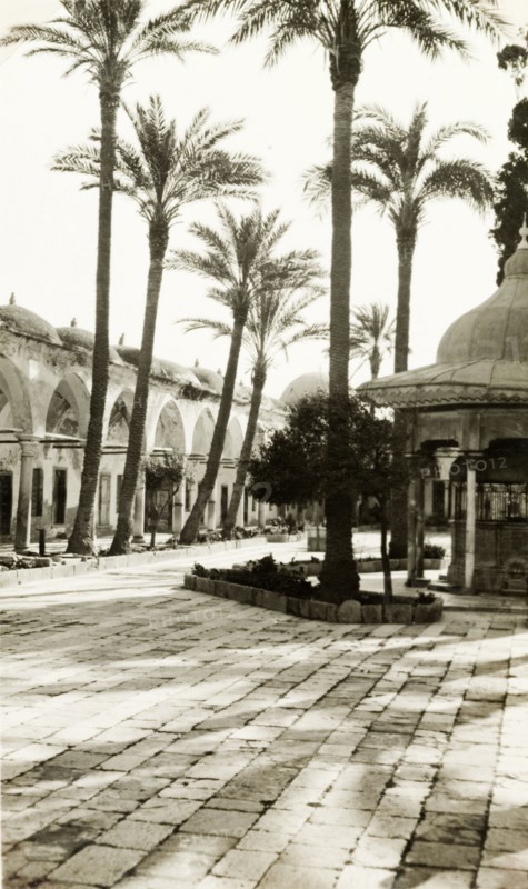 Purification fountain in Acre. A purification fountain sits outside a colonnade at the entrance to the 18th century Al Jezzar Mosque. Acre (Akko), British Mandate of Palestine (Northern Israel), circa 1940. Akko, North (Israel), Israel, Middle East, Asia.