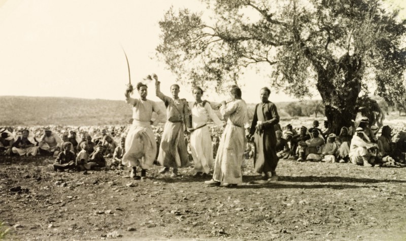 Dabke' dance at a Palestinian wedding. A group of men dressed in 'thobs' (ankle-length garments with long sleeves) perform a traditional 'dabke' folk dance at a Palestinian wedding. Salfit, British Mandate of Palestine (West Bank, Middle East), 17 September 1941. Salfit, West Bank, West Bank (Palestine), Middle East, Asia.