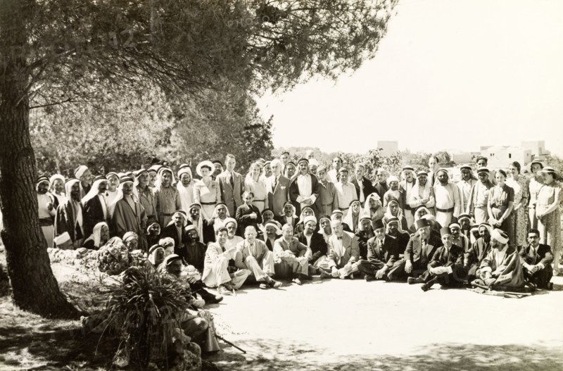 Arab mukhtars at a District Commissioner's party. A large group of Arab mukhtars (headmen) pose for a group portrait with British officials and their wives at a party organised by the District Commissioner. Qubeiba, British Mandate of Palestine (West Bank, Middle East), 1941. Qubeiba, West Bank, West Bank (Palestine), Middle East, Asia.
