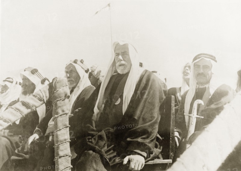 The Mayor of Be'er Sheva watches a camel race. The Mayor of Be'er Sheva, Sheikh Taj ed Din es Sha'ath, sits on a raised dais with other Arab dignitaries as he watches a camel race. Be'er Sheva, British Mandate of Palestine (South Israel), 27 February 1944. Be'er Sheva, South (Israel), Israel, Middle East, Asia.