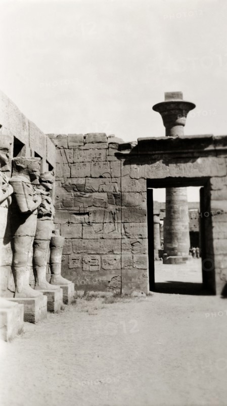 Temple of Ramesses III at Karnak. A line of eroded stone statues guard a courtyard in the Temple of Ramesses III, one of several buildings belonging to the Karnak Temple complex. Karnak, Egypt, February 1945., Qina, Egypt, Northern Africa, Africa.