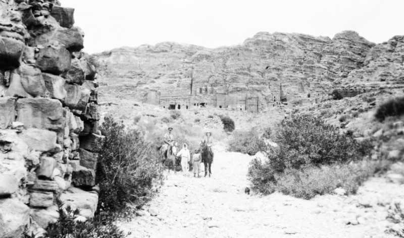 In the valley below Petra. Arab guides lead a European couple on horseback as they visit the cliff structures at Petra, an ancient Nabatean city on the eastern flank of the Arabah. Petra, Transjordan (Jordan), May 1945., Jordan, Jordan, Middle East, Asia.