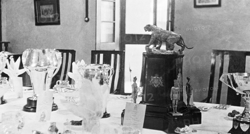 A table set for a formal dinner. Various trophies form the centrepiece of a table that has been set for a formal dinner for the Inspector-General of Police, Harold Poe, at Moradabad's Police Training School. Moradabad, United Provinces (Uttar Pradesh), India, circa 1933. Moradabad, Uttar Pradesh, India, Southern Asia, Asia.