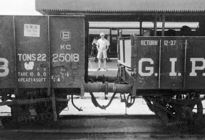 George Boon at Meerut railway station. Portrait of George Boon, an officer of the Indian Police, captured on the platform at Meerut railway station between two stationary freight carriages. Meerut, United Provinces (Uttar Pradesh), India, May 1935. Meerut, Uttar Pradesh, India, Southern Asia, Asia.