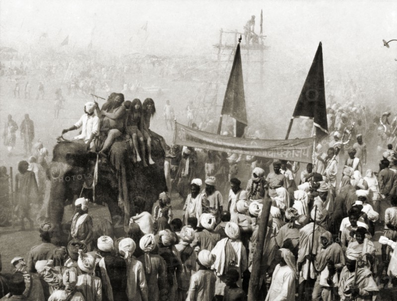 Procession at the Ardh Kumbh Mela. A procession containing elephants and banners passes through crowds of Hindu pilgrims on its way to the Triveni Sangam (the holy confluence of the Yamuna, Saraswati and Ganges Rivers) at the Ardh Kumbh Mela. Allahabad, United Provinces (Uttar Pradesh), India, January 1936. Allahabad, Uttar Pradesh, India, Southern Asia, Asia.