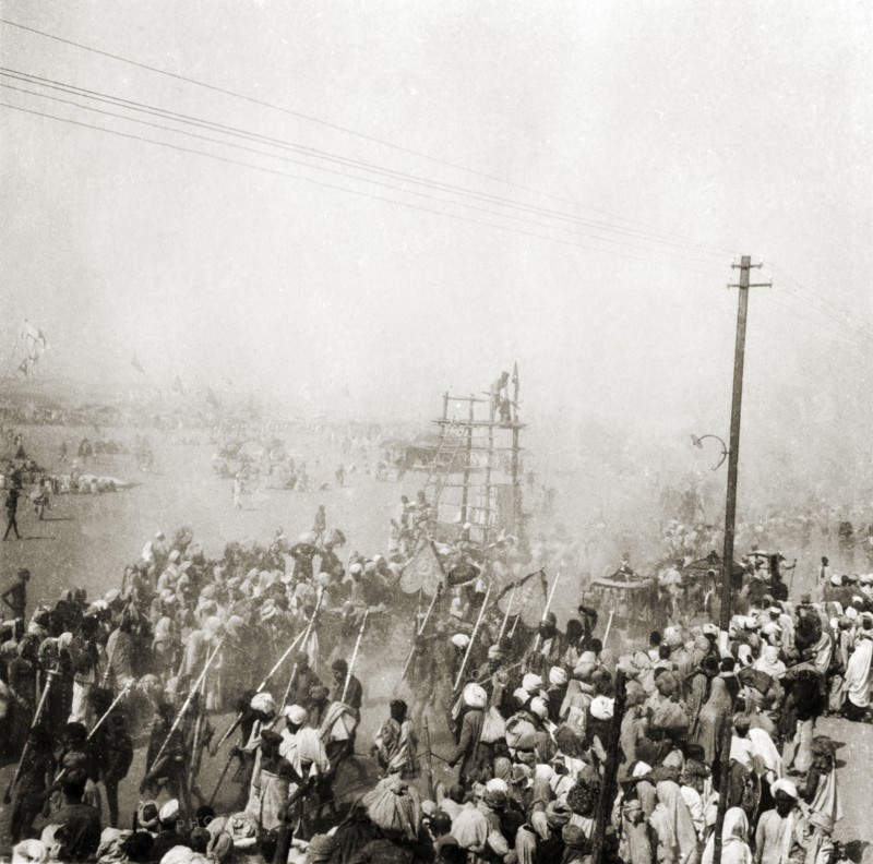 Procession at the Ardh Kumbh Mela. A procession passes through crowds of Hindu pilgrims on its way to the Triveni Sangam (the holy confluence of the Yamuna, Saraswati and Ganges Rivers) at the Ardh Kumbh Mela. Allahabad, United Provinces (Uttar Pradesh), India, January 1936. Allahabad, Uttar Pradesh, India, Southern Asia, Asia.