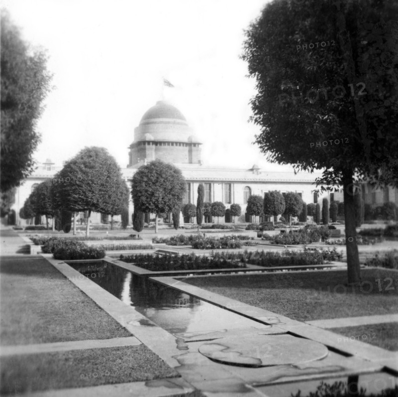 View of the Viceroy's House in New Delhi. View across Mughal-style gardens, looking towards the Viceroy's House (Rashtrapati Bhavan), where a union jack flies from the top of its dome. New Delhi, India, December 1939. Delhi, Delhi, India, Southern Asia, Asia.