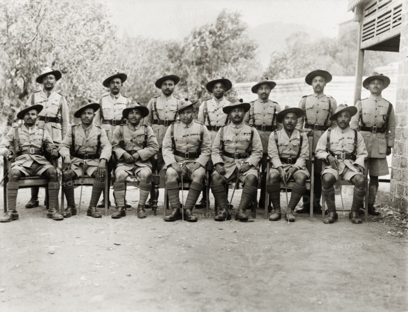 Asian officers of the Eighth Royal Gurkha Rifles. Asian officers of the Eighth Royal Gurkha Rifles pose for a group portrait, dressed in full uniform with marching canes. North West Frontier Province, India (Pakistan), 1920., North West Frontier Province, Pakistan, Southern Asia, Asia.