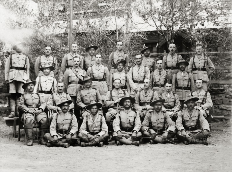 Officers of the Eighth Royal Gurkha Rifles. Asian and European officers of the Eighth Royal Gurkha Rifles pose for a group portrait, dressed in full uniform with marching canes and walking sticks. North West Frontier Province, India (Pakistan), 1920., North West Frontier Province, Pakistan, Southern Asia, Asia.