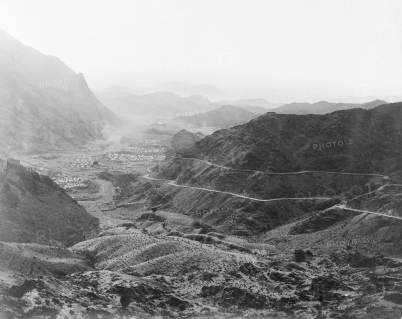 Military camp on the Khyber Pass. Two roads wind towards an Indian Army camp, located in a mountain valley on the Khyber Pass. The camp is protected by earthworks and contains numerous bell tents. North West Frontier Province, India (Federally Administered Tribal Areas, Pakistan), circa 1919., Federally Administered Tribal Areas, Pakistan, Southern Asia, Asia.