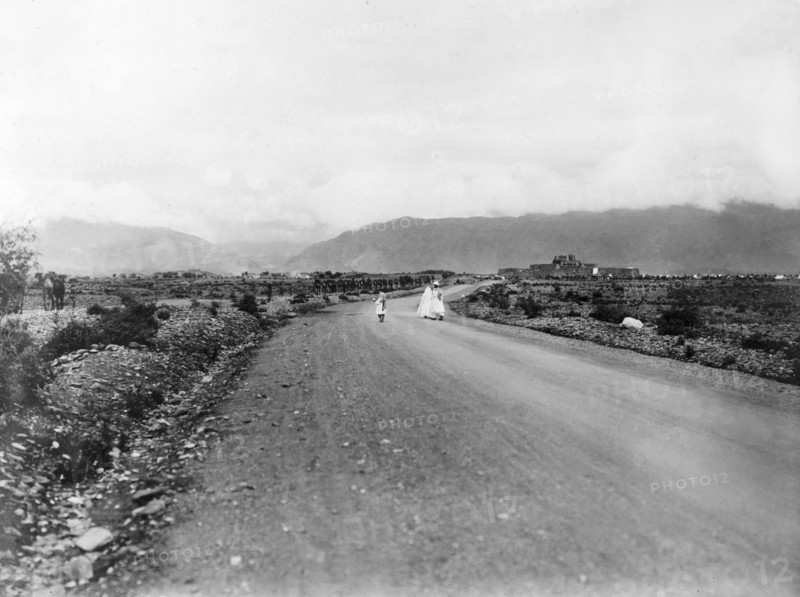 The road to Jamrud Fort. A convoy of camels is led along a road towards Jamrud Fort, a mud fort built by Sikh General Hari Singh Nalwa in 1837. An original caption comments: "The entrance to the (Khyber) Pass is four miles further on (through) the gap in the hills...". Jamrud, North West Frontier Province, India (Pakistan), 1919. Jamrud, North West Frontier Province, Pakistan, Southern Asia, Asia.