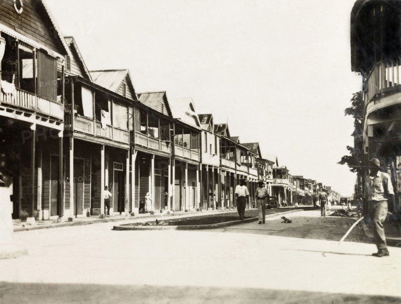 City street in Colon, Panama. Wooden, balconied buildings line the main street running through the port city of Colon. Colon, Panama, circa 1930. Colon, Colon, Panama, Central America, North America .