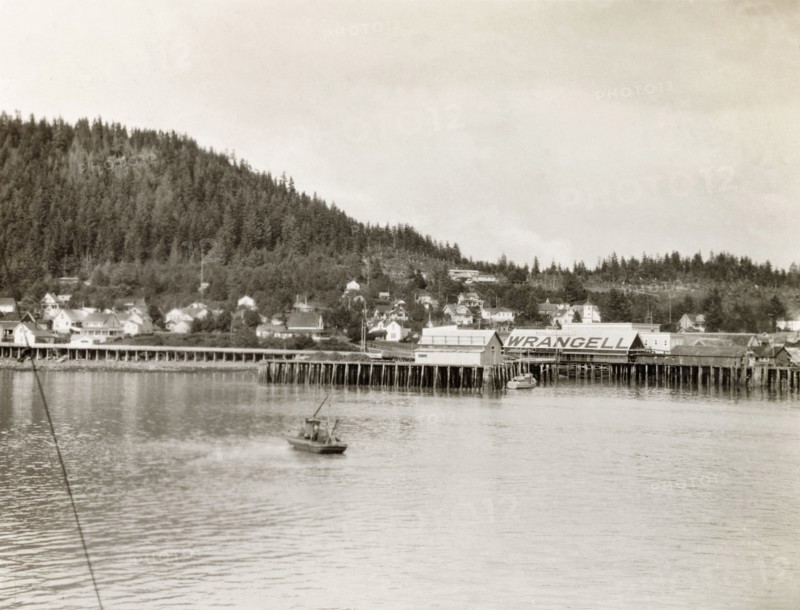 Wrangell pier, Alaska. A wooden pier stretches into the waters of the Zimovia Strait at the coastal town of Wrangell. Wrangell, Alaska, United States of America, circa 1931. Wrangell, Alaska, United States of America, North America, North America .