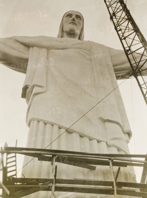 Christ the Redeemer, Rio de Janeiro. Rio de Janeiro's landmark statue of Christ the Redeemer, pictured around the time of its inauguration on 12 October 1931. Designed in Art Deco style by Polish-French sculptor Paul Landowski, the statue is 710 metres tall and stands atop Corcovado Mountain overlooking the city. Rio de Janeiro, Brazil, circa 1931. Rio de Janeiro, Brazil, Brazil, South America, South America .