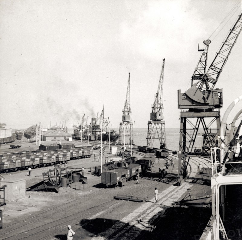Mormugao docks. Dockside cranes and freight cars at Mormugao Port. Mormugao, Goa, India, circa 1937. Mormugao, Goa, India, Southern Asia, Asia.